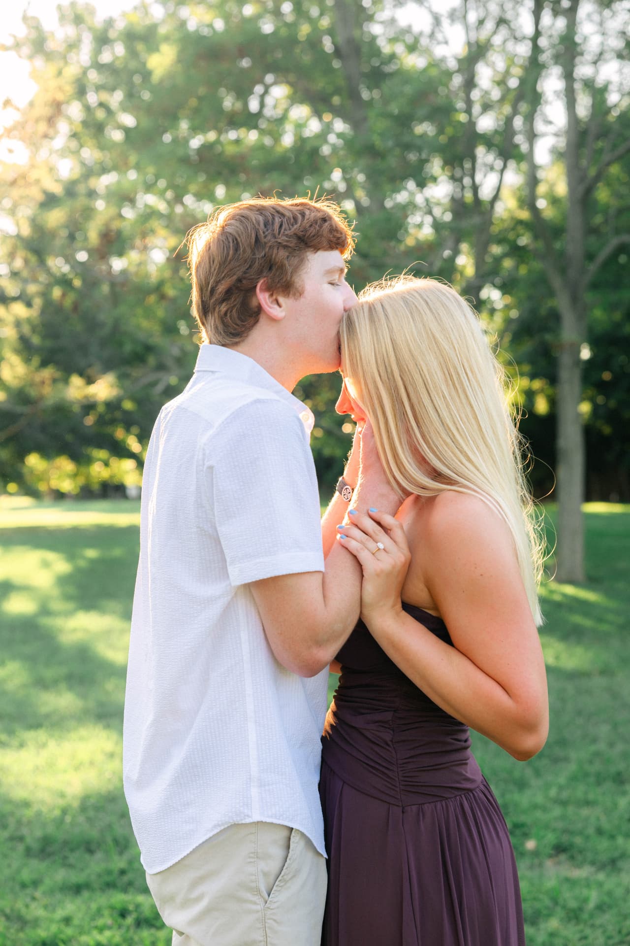 Colin kissing Samantha's forehead in the park