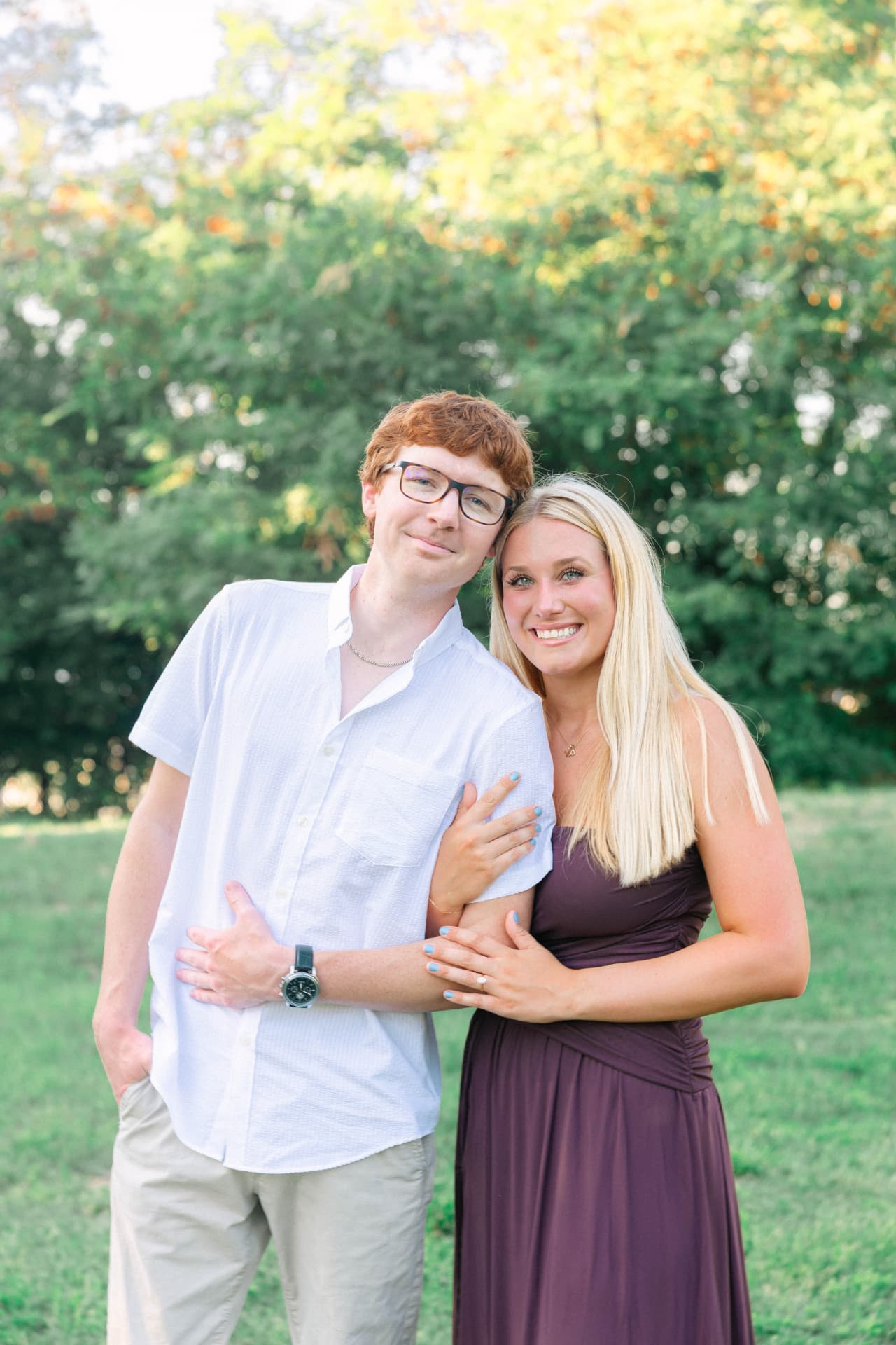 Samantha and Colin standing together in the park at golden hour