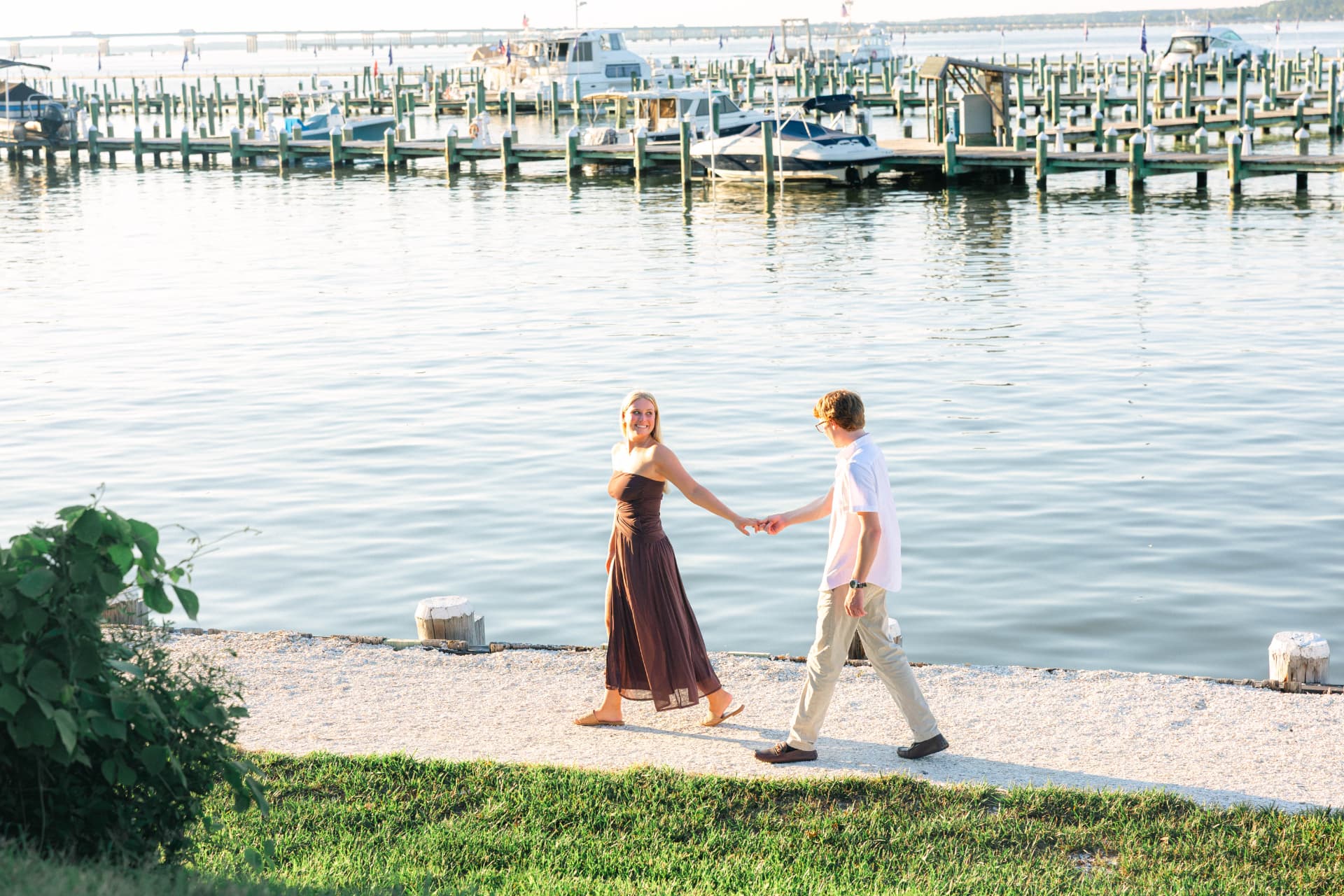 Colin leading Samantha by the hand along the marina path